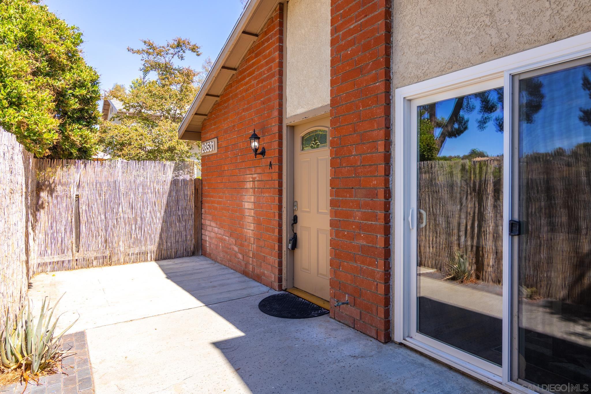 a view of backyard with tub and door