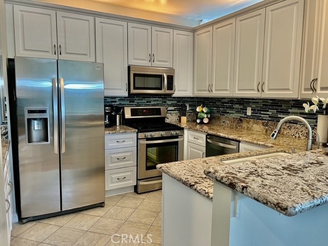 a kitchen with appliances a sink and cabinets