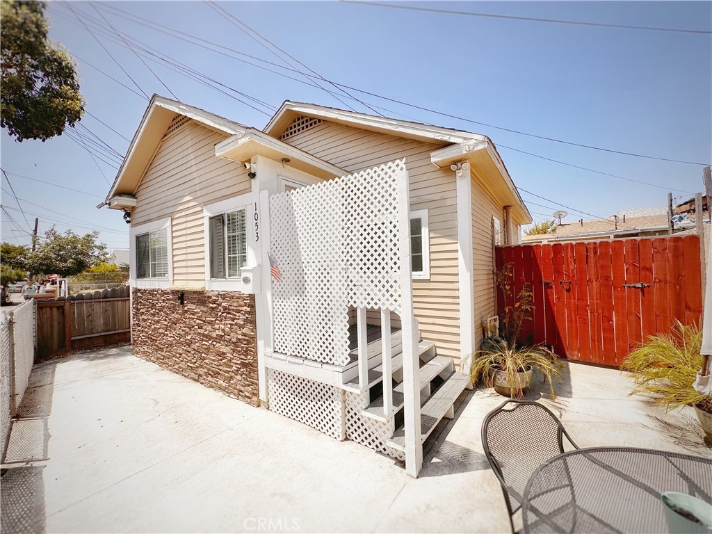 a view of a backyard with furniture and a garage