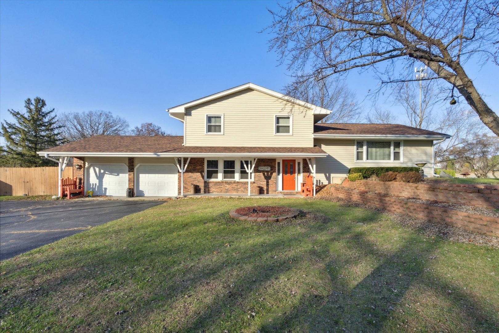 a view of house with yard and sitting area