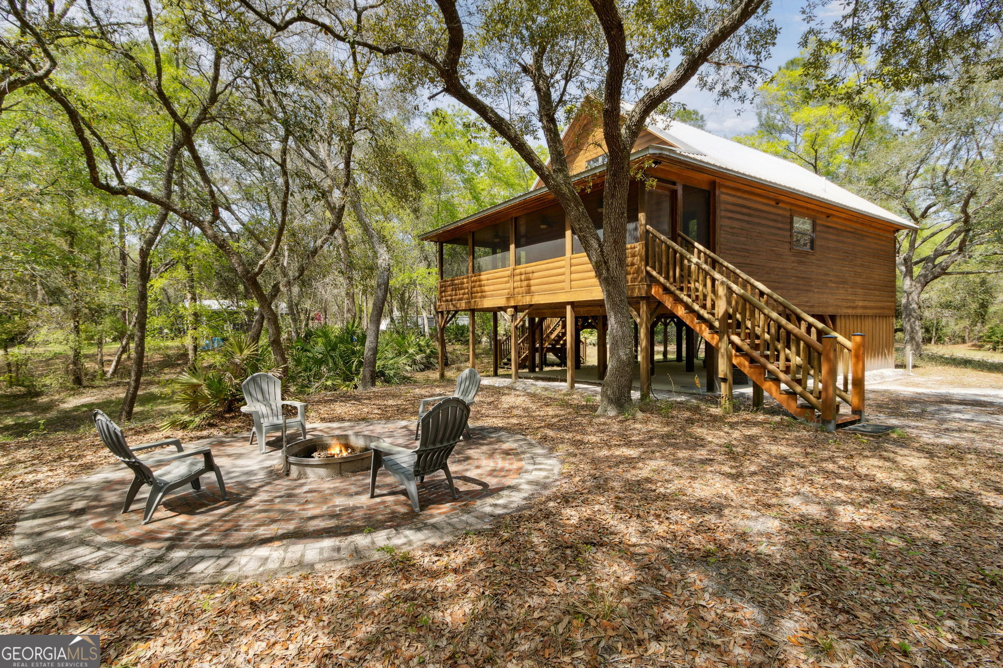 a view of a building with a yard and sitting area