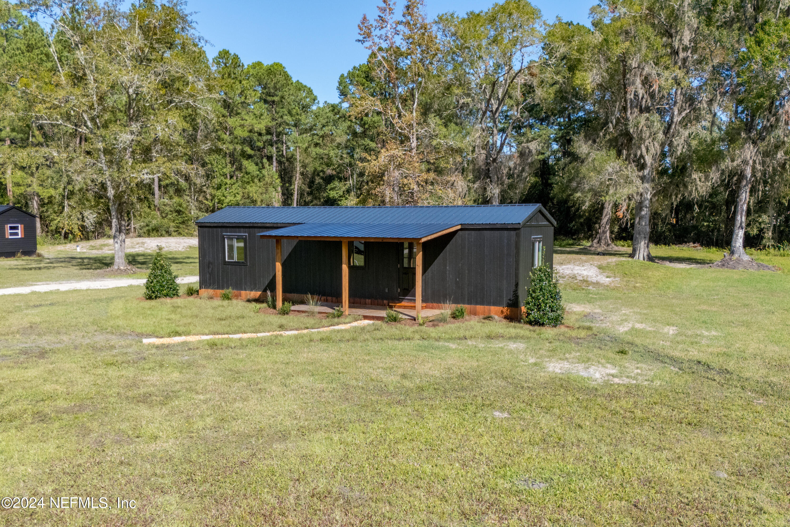 a view of a house with a yard and garage