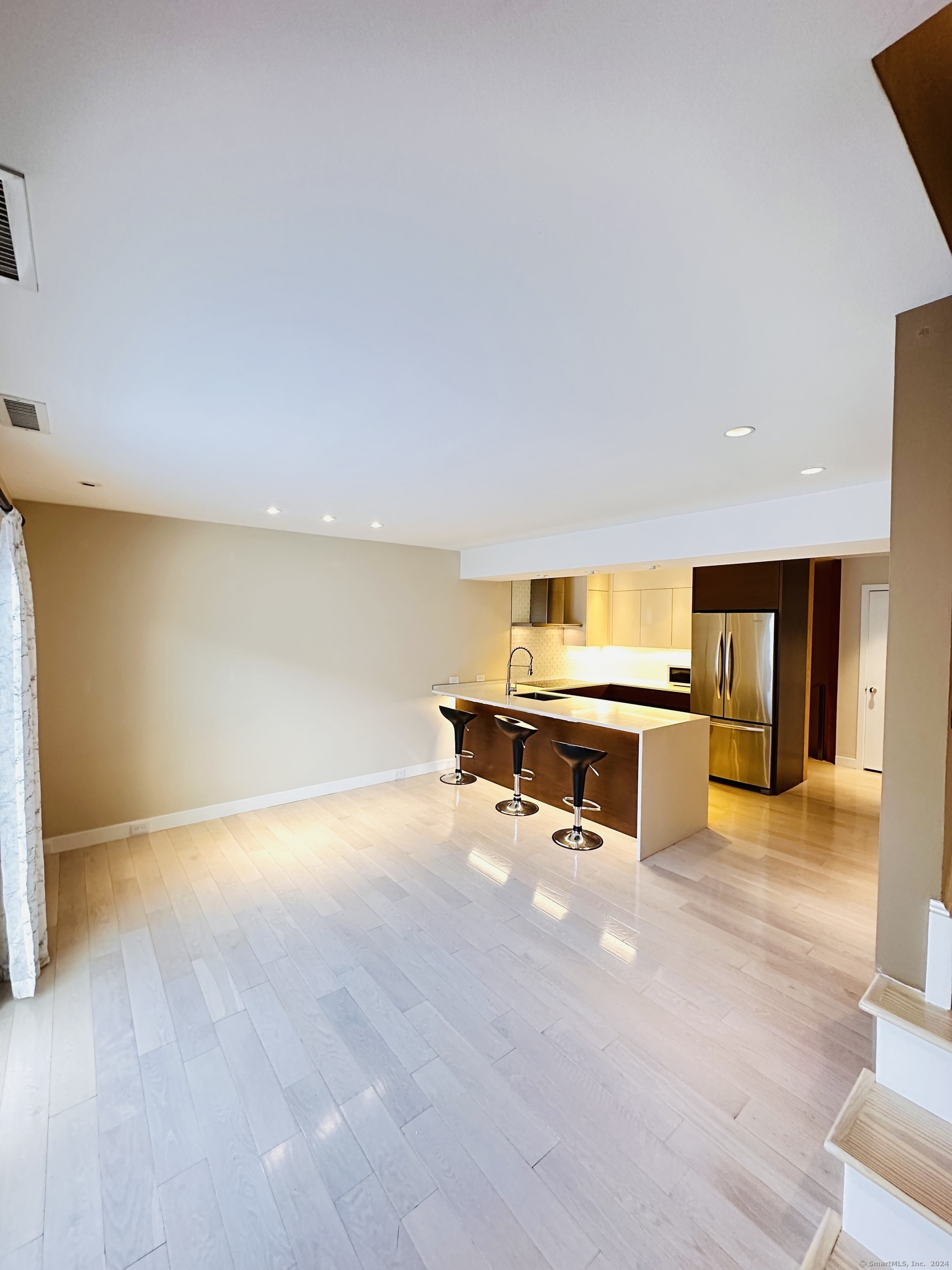 a view of an empty room with a kitchen