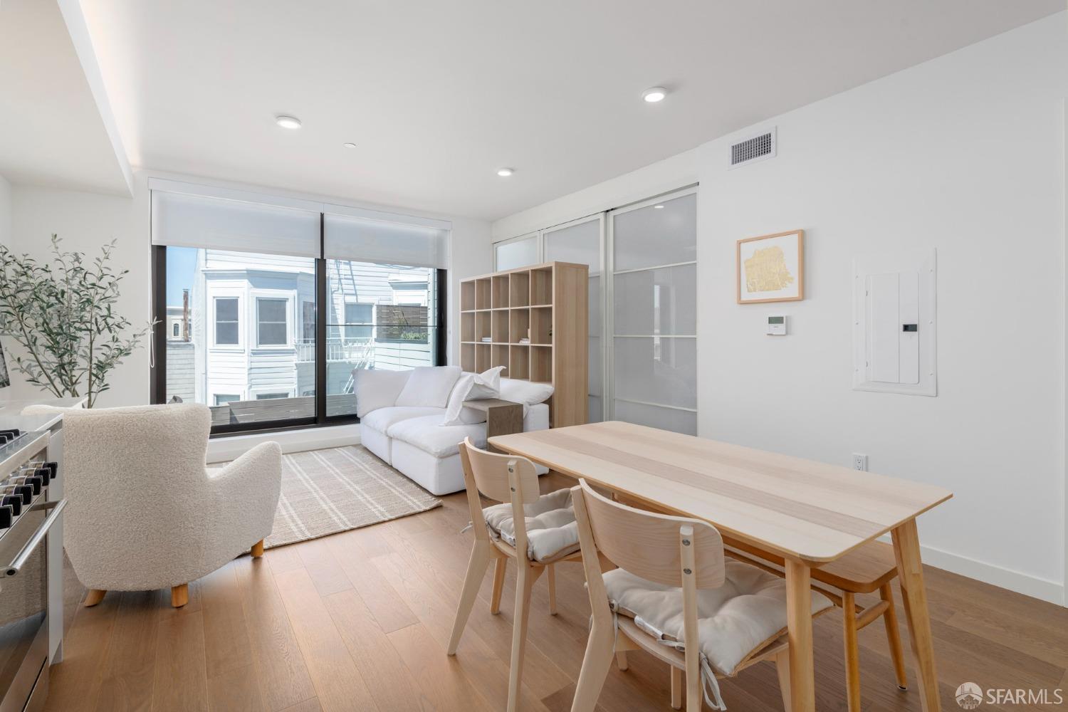 a living room with furniture a flat screen tv and a table