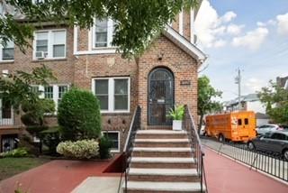 a front view of a house with a garden