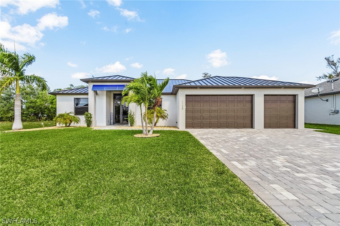 a front view of a house with a yard and a garage