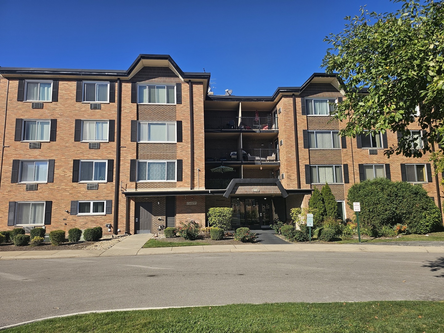 a front view of a residential apartment building with a yard