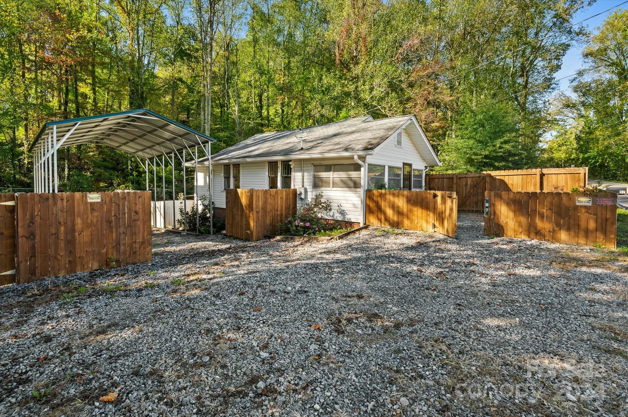 a view of a house with backyard and a tree