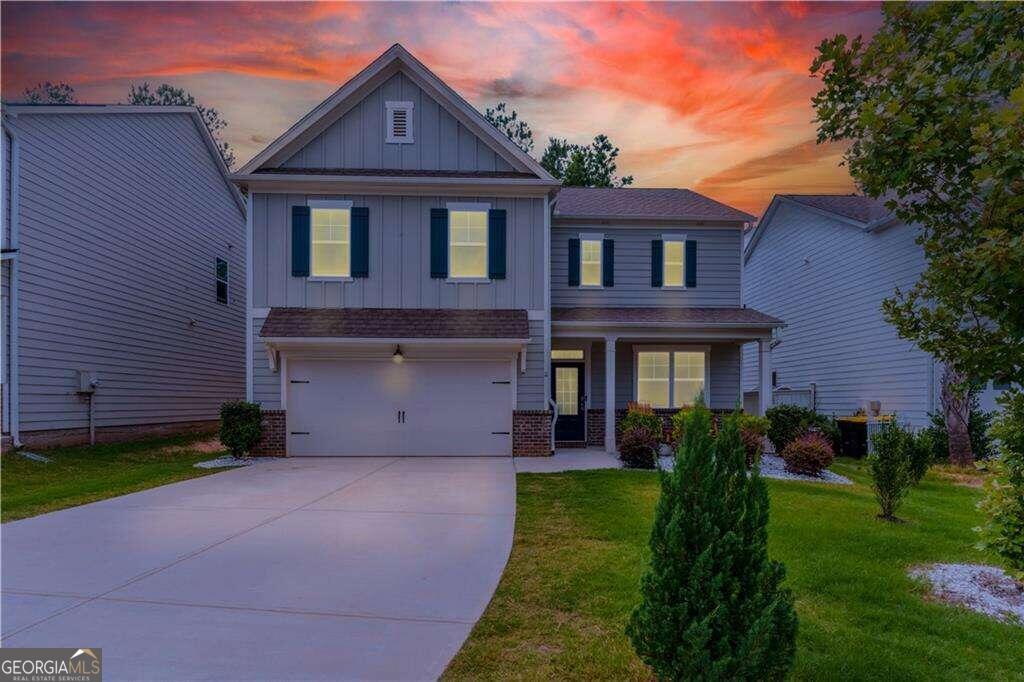 a front view of a house with a yard and garage