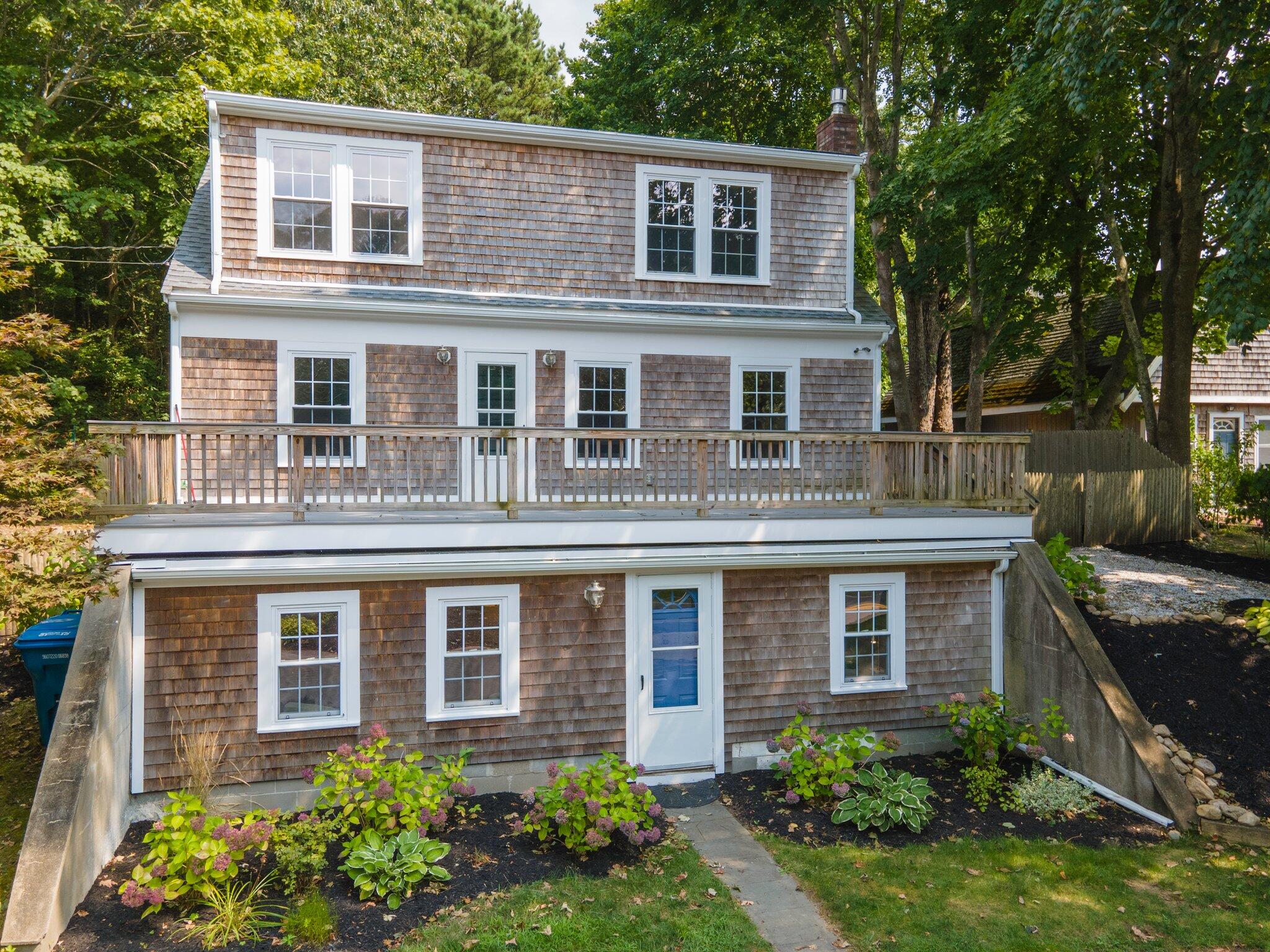 a front view of a house with a garden