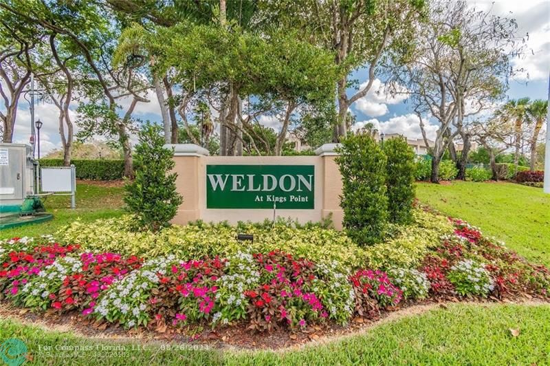 a view of sign board with green field