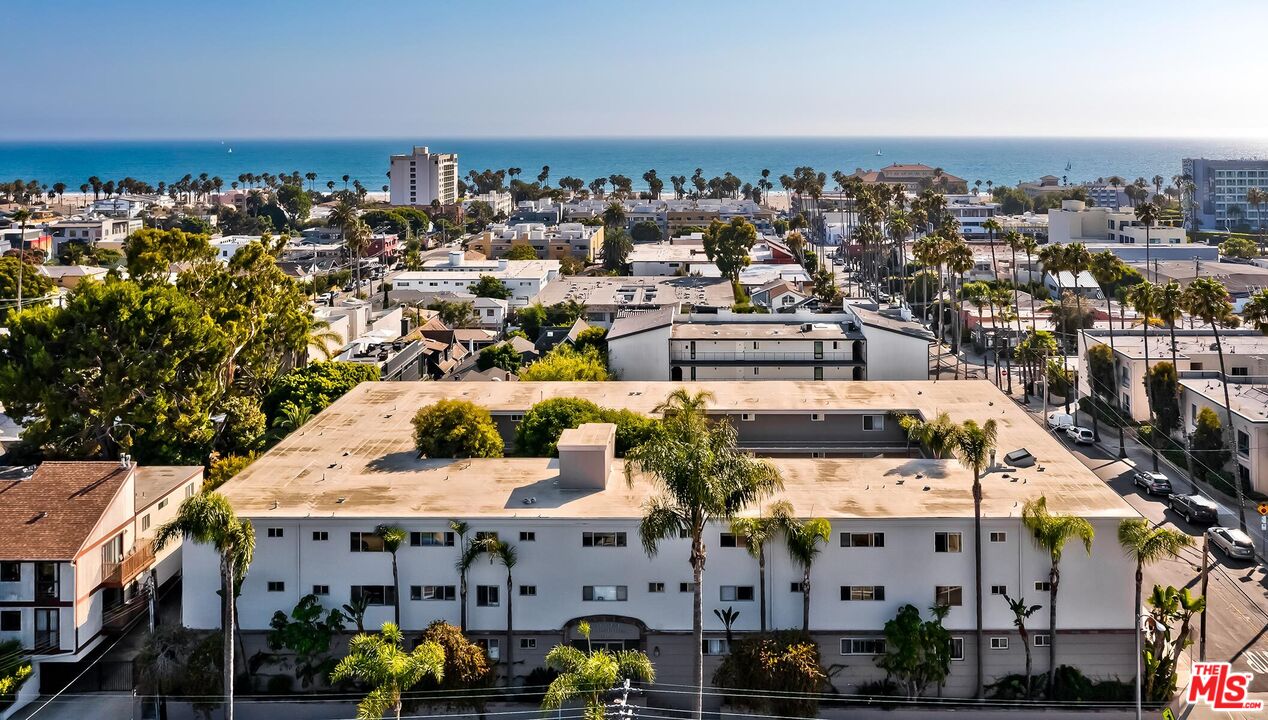 an aerial view of a building with parking