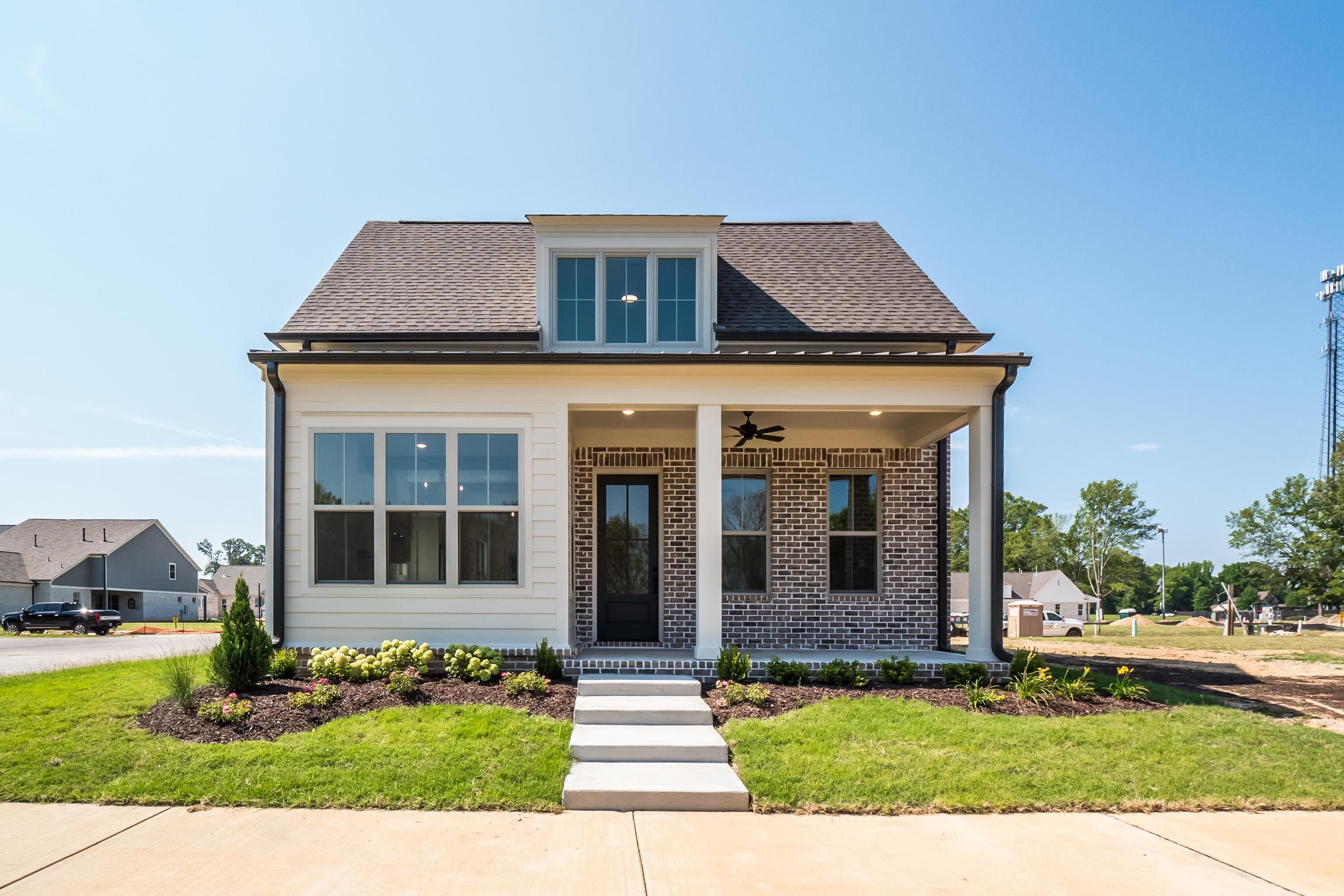 Bungalow featuring ceiling fan, a porch, and a front yard