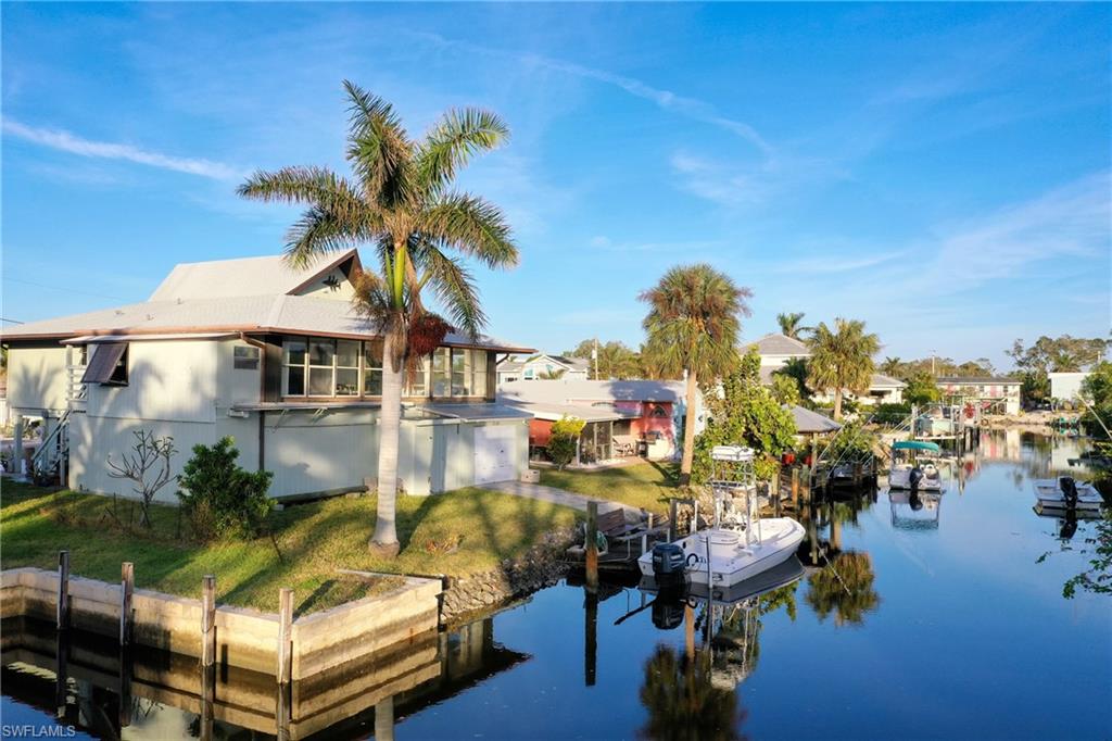 Dock area featuring a lawn and a water view