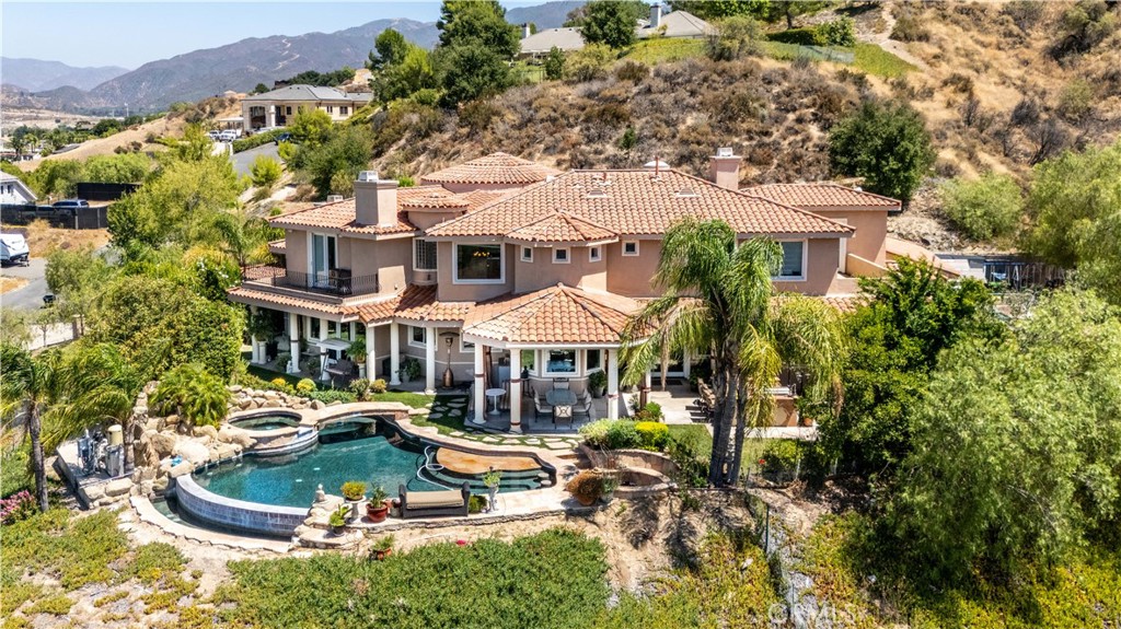 an aerial view of a house with a yard basket ball court and outdoor seating