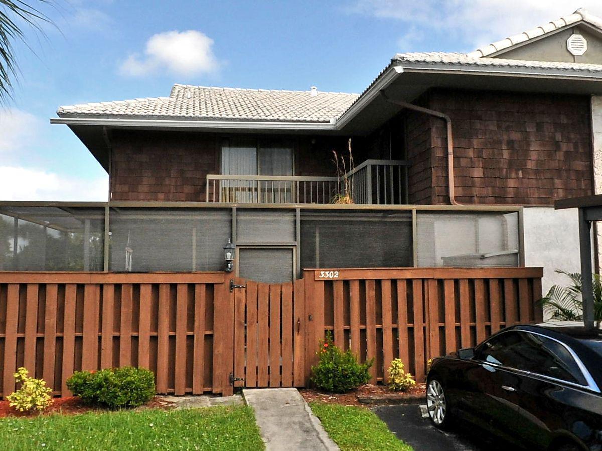 a view of a house with wooden fence