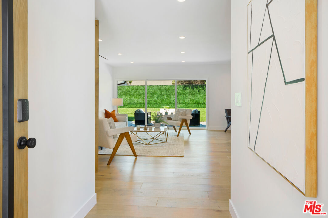 a view of living room with furniture and floor to ceiling window