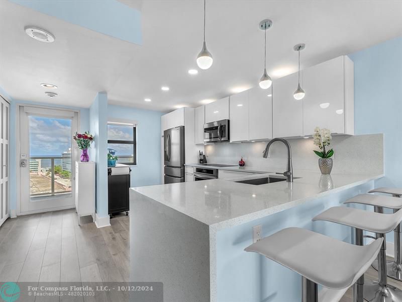 a large kitchen with stainless steel appliances kitchen island a large island in the center