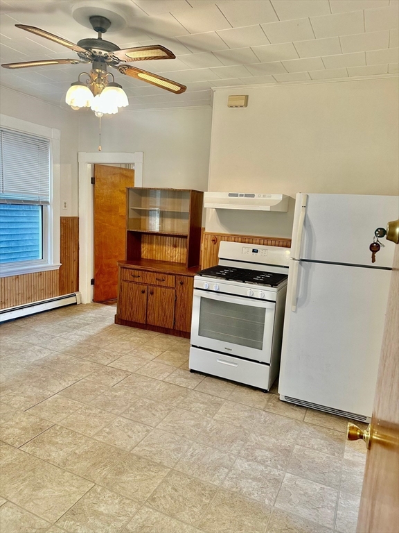 a kitchen with granite countertop a stove top oven and cabinets