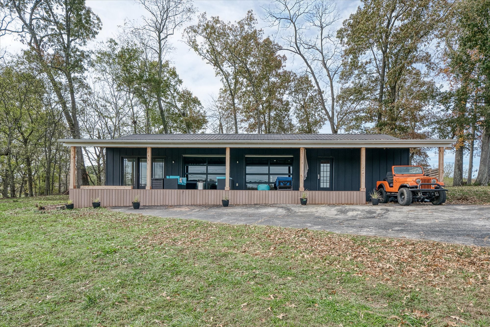 a view of a house with a patio and a yard