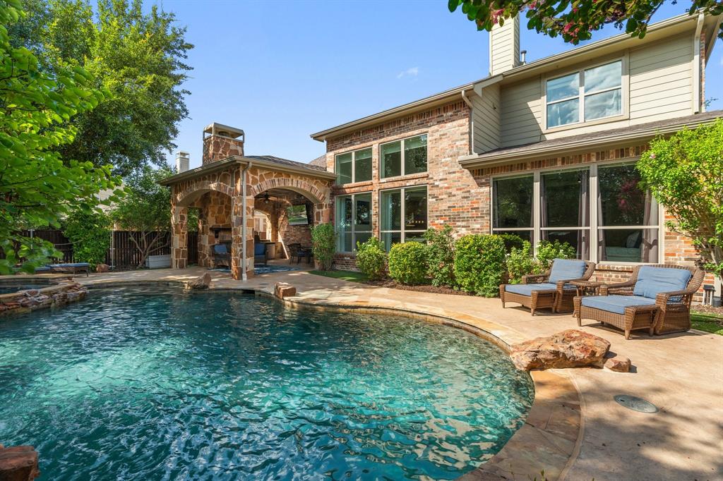 a front view of a house with swimming pool and porch