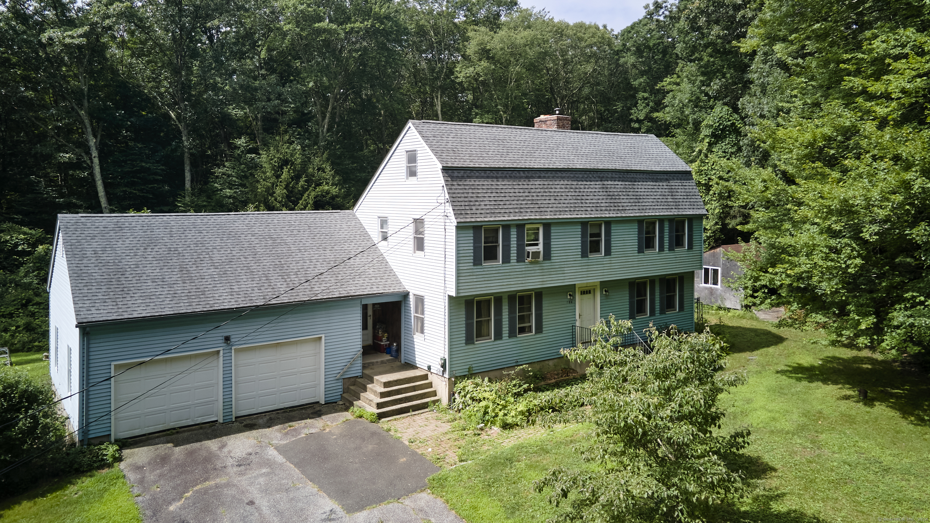 an aerial view of a house with a yard and balcony