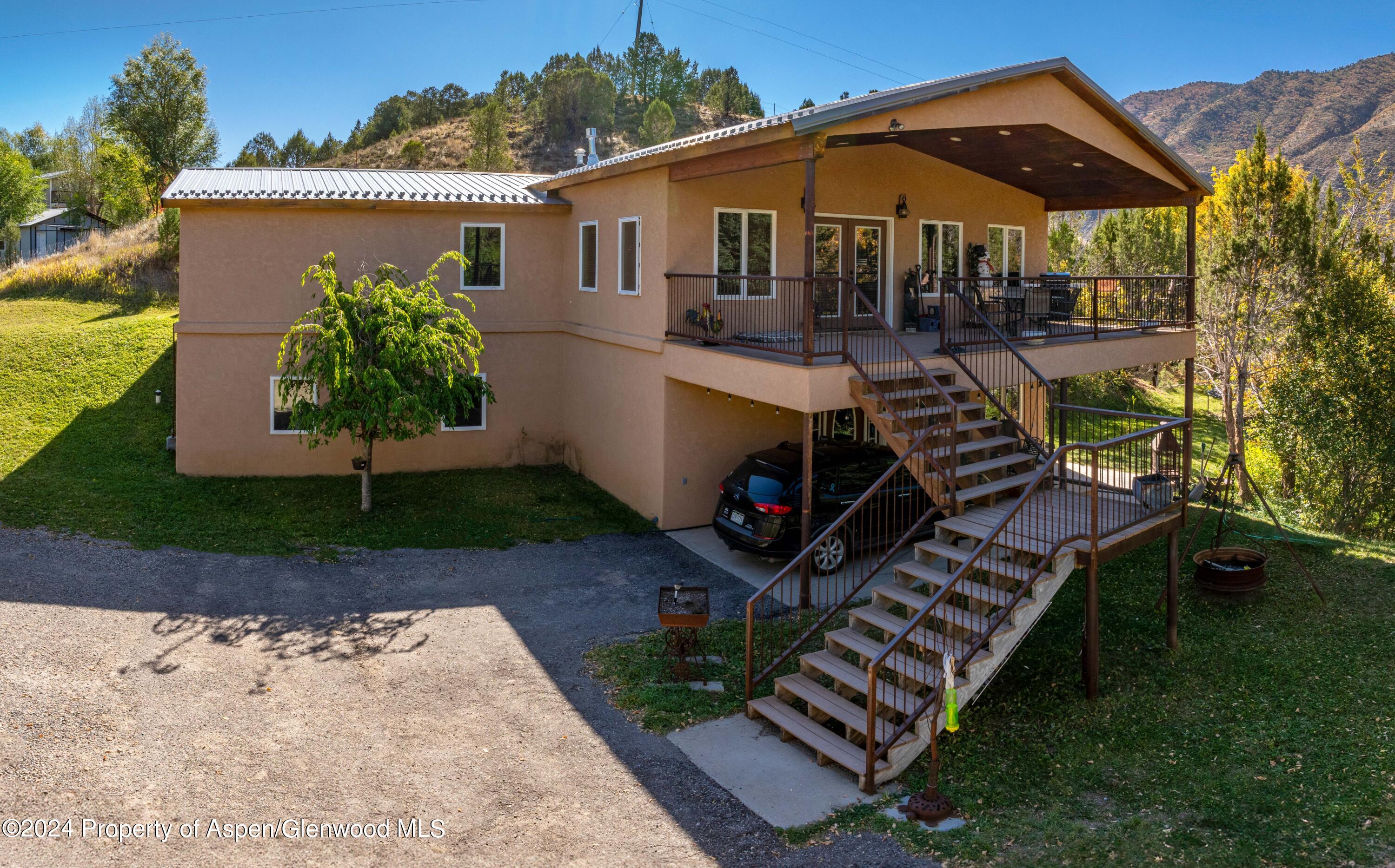 a view of a house with backyard and sitting area