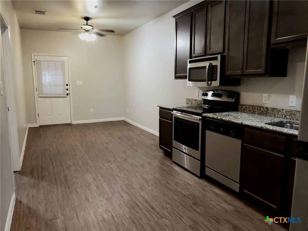 a kitchen with a sink appliances and cabinets