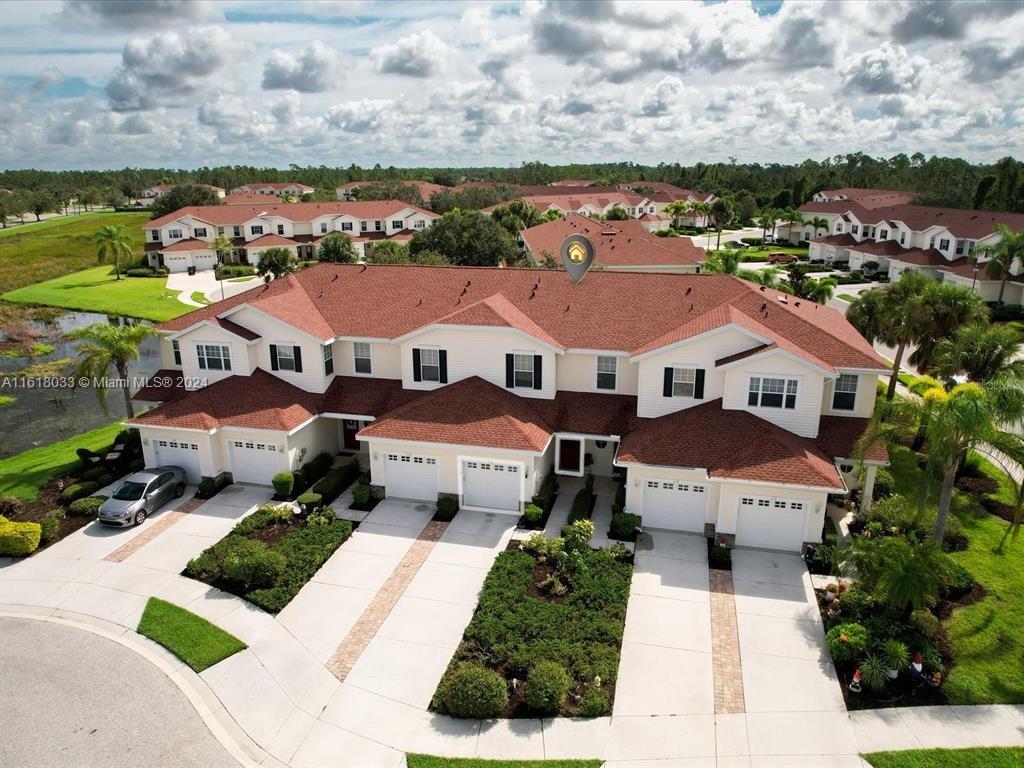 a view of multiple houses with a big yard