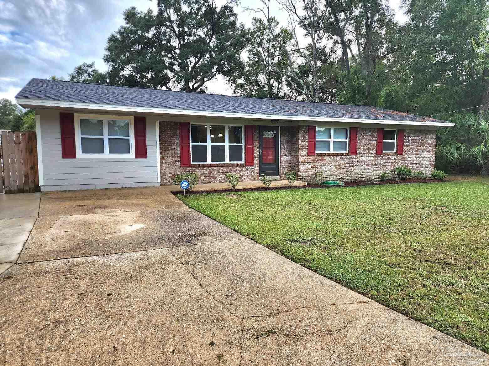 a view of a house with a backyard