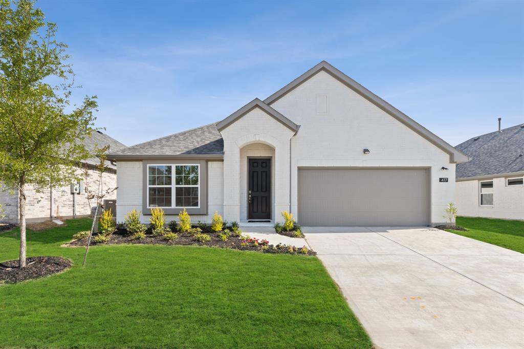 a front view of house with yard and green space