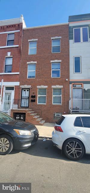 a view of a car parked in front of a brick building