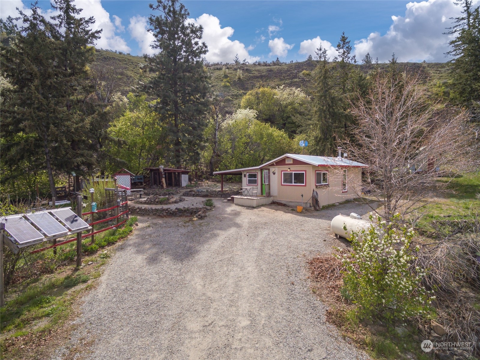 a view of house with yard and car parked