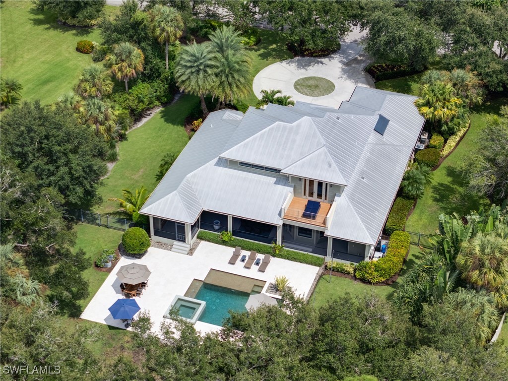 an aerial view of a house with yard and green space