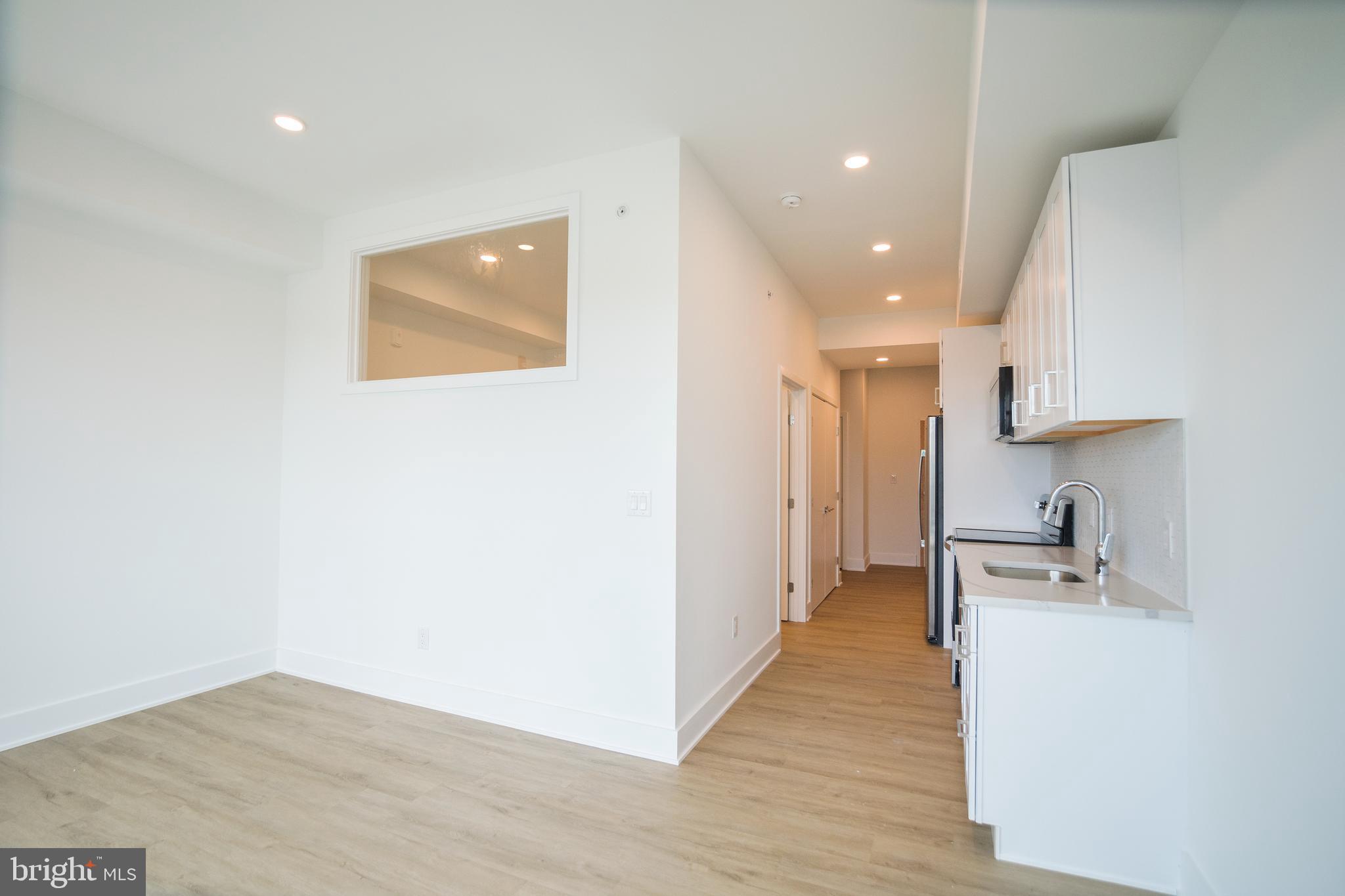 a view of a kitchen with a sink and cabinets