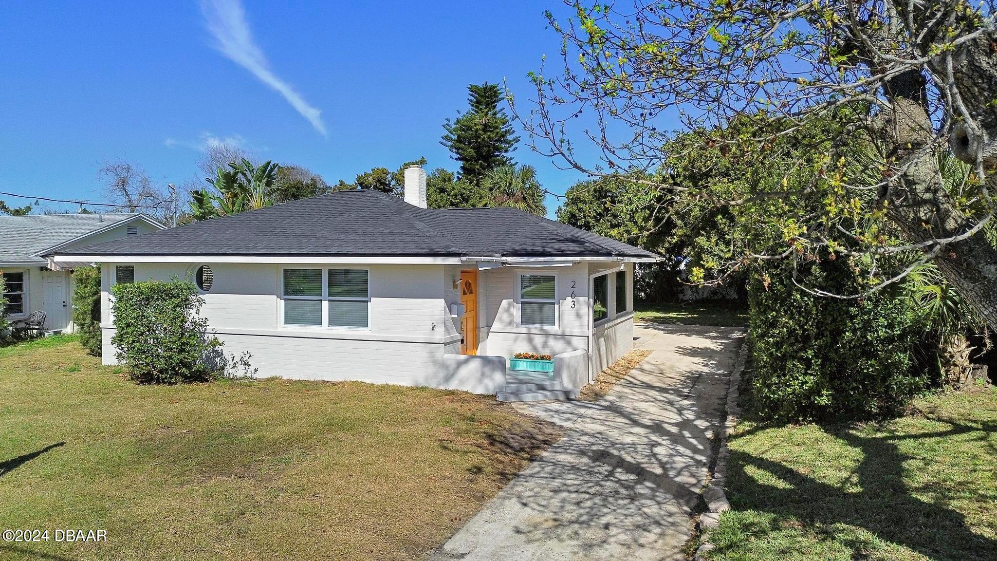 a front view of a house with a yard