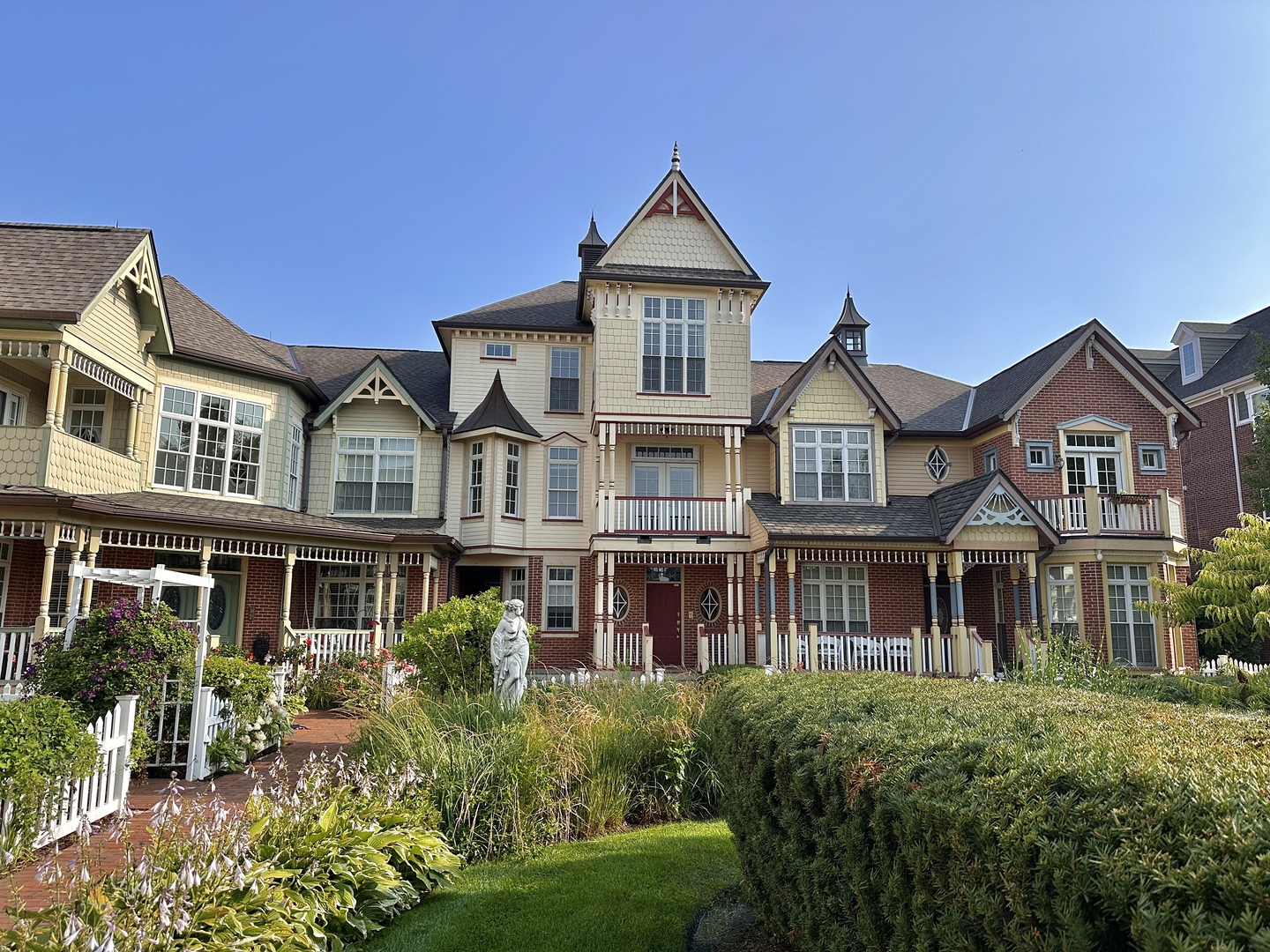 a front view of residential houses with yard and green space