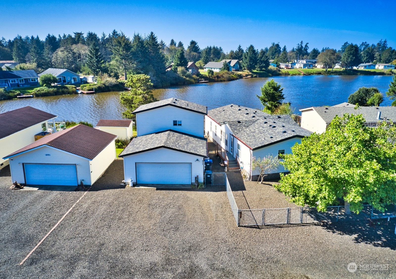 an aerial view of a house with garden space and lake view