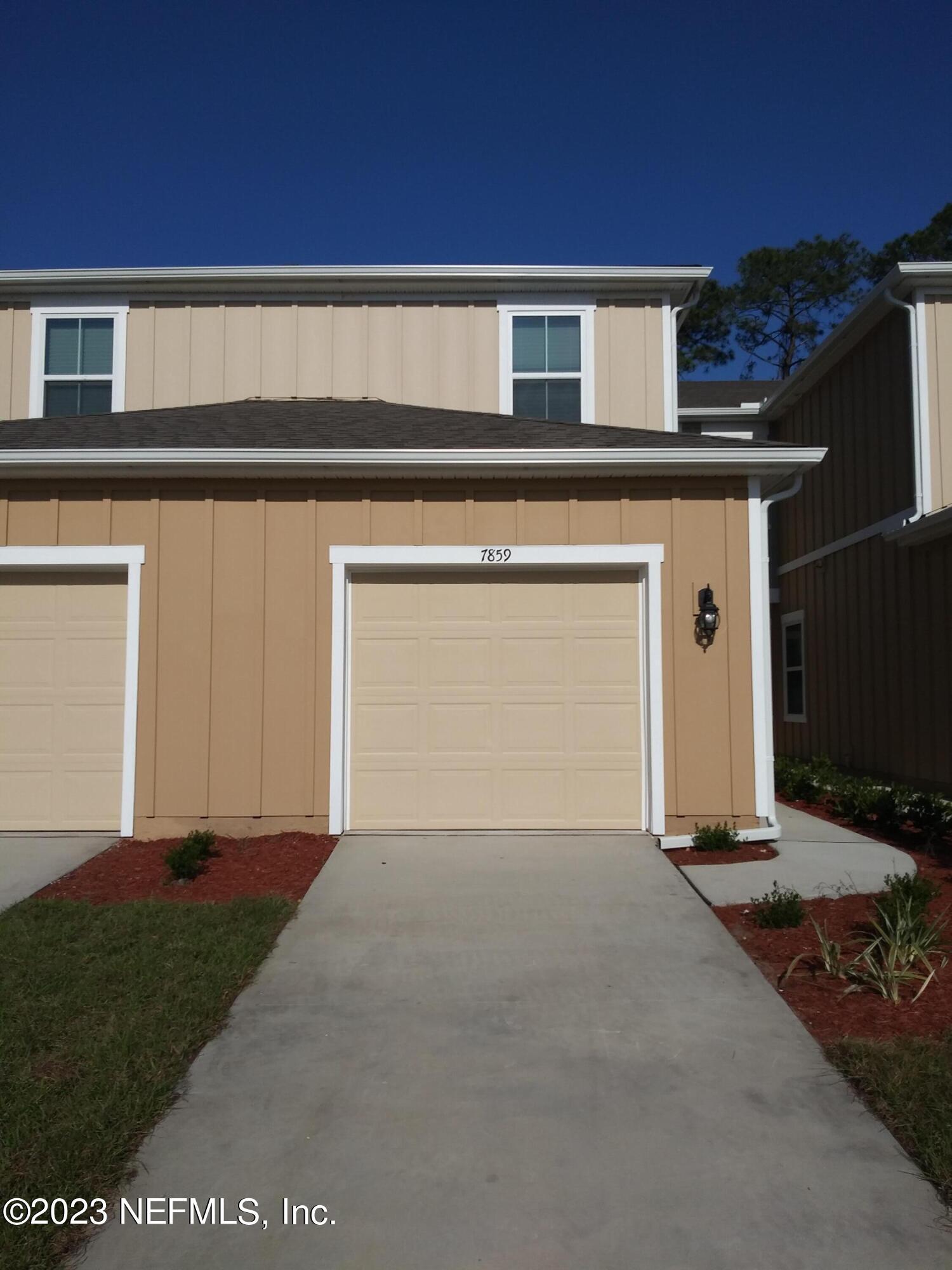 a front view of a house with a garage