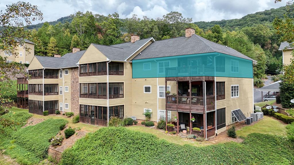 a aerial view of a house with yard and patio