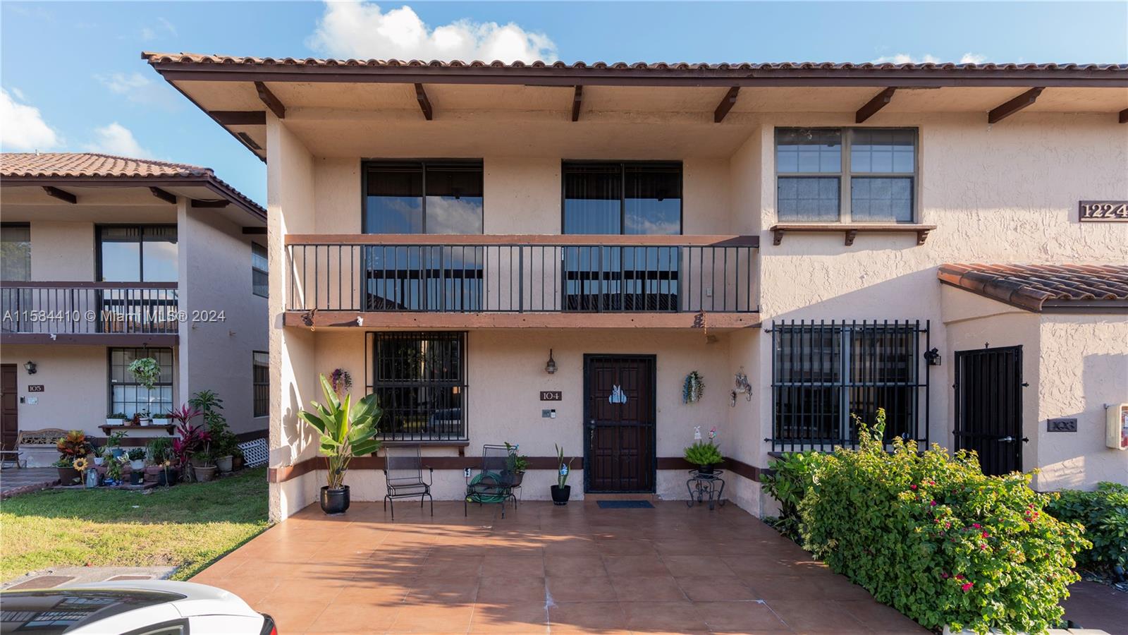 a front view of a building with sitting space and porch