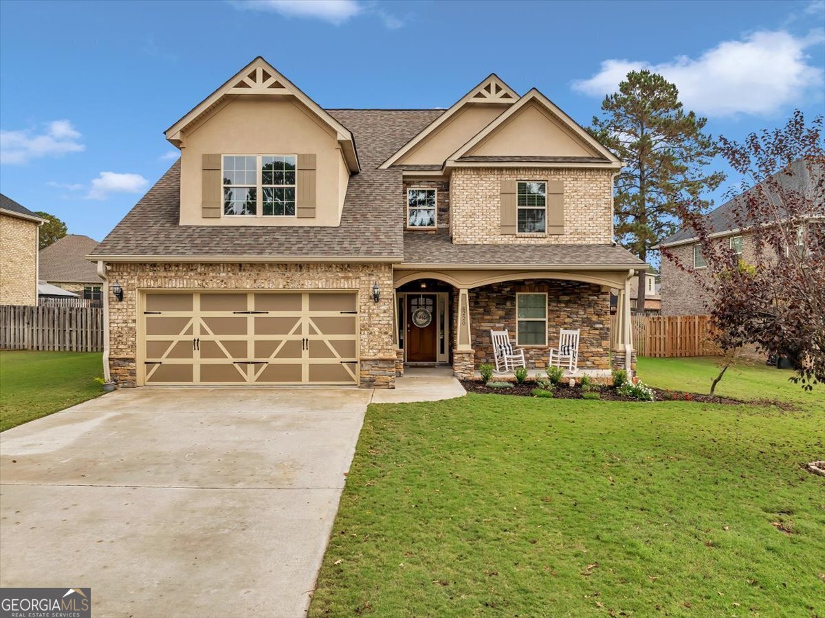 a front view of a house with a yard and garage