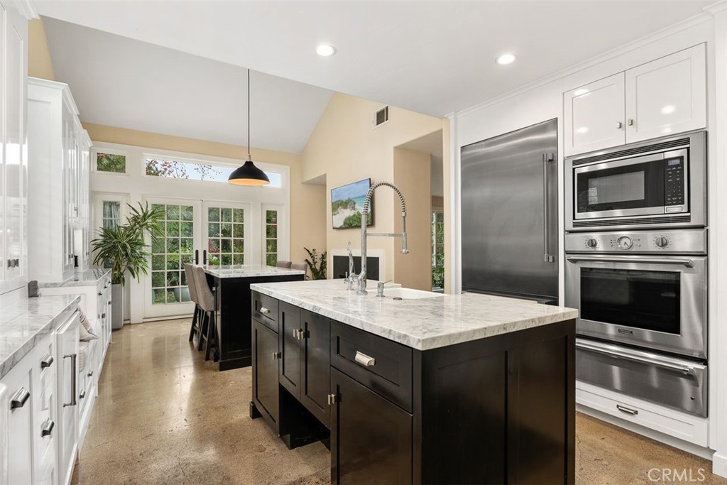 a kitchen with a sink stove and refrigerator