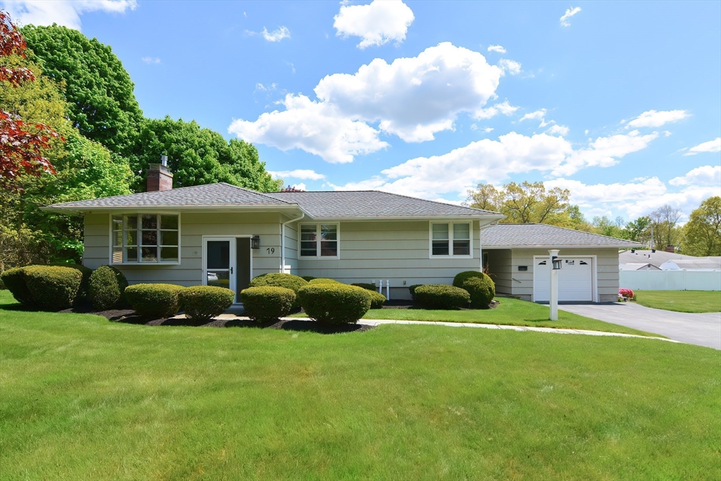 a front view of a house with garden and porch