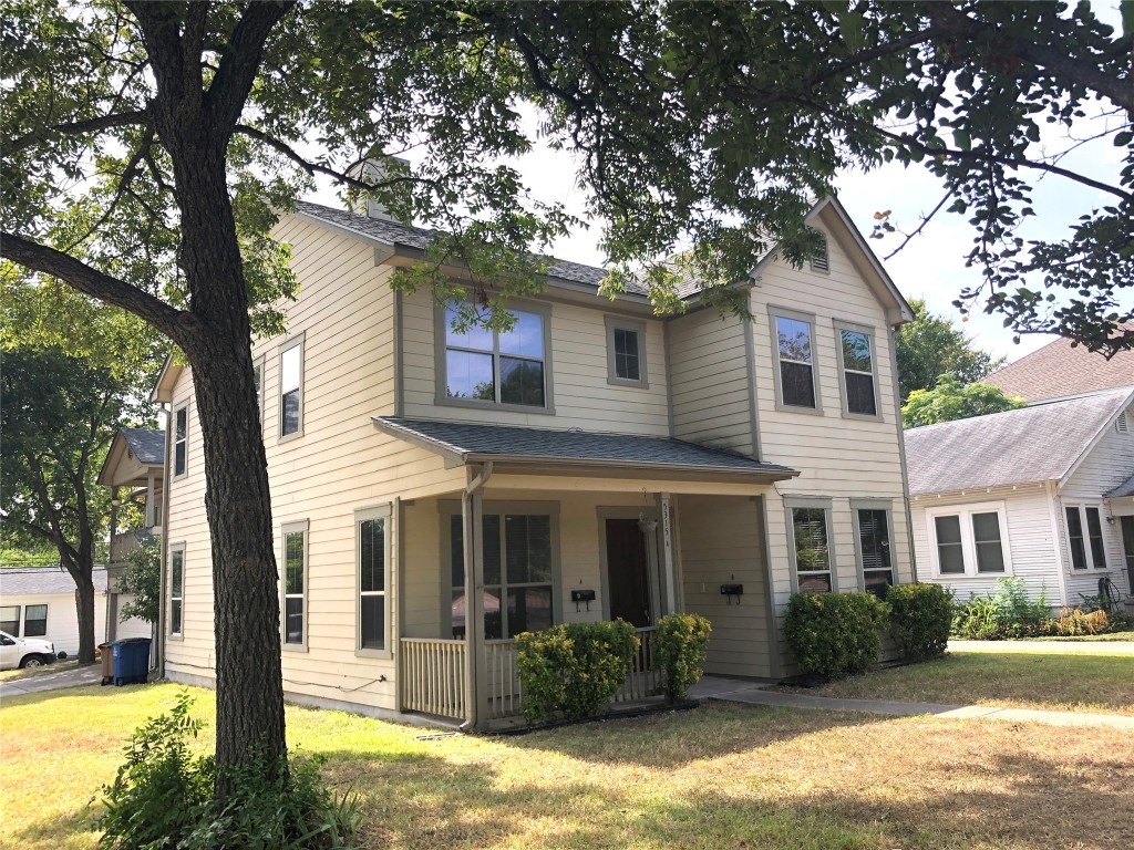 a front view of a house with a yard and porch