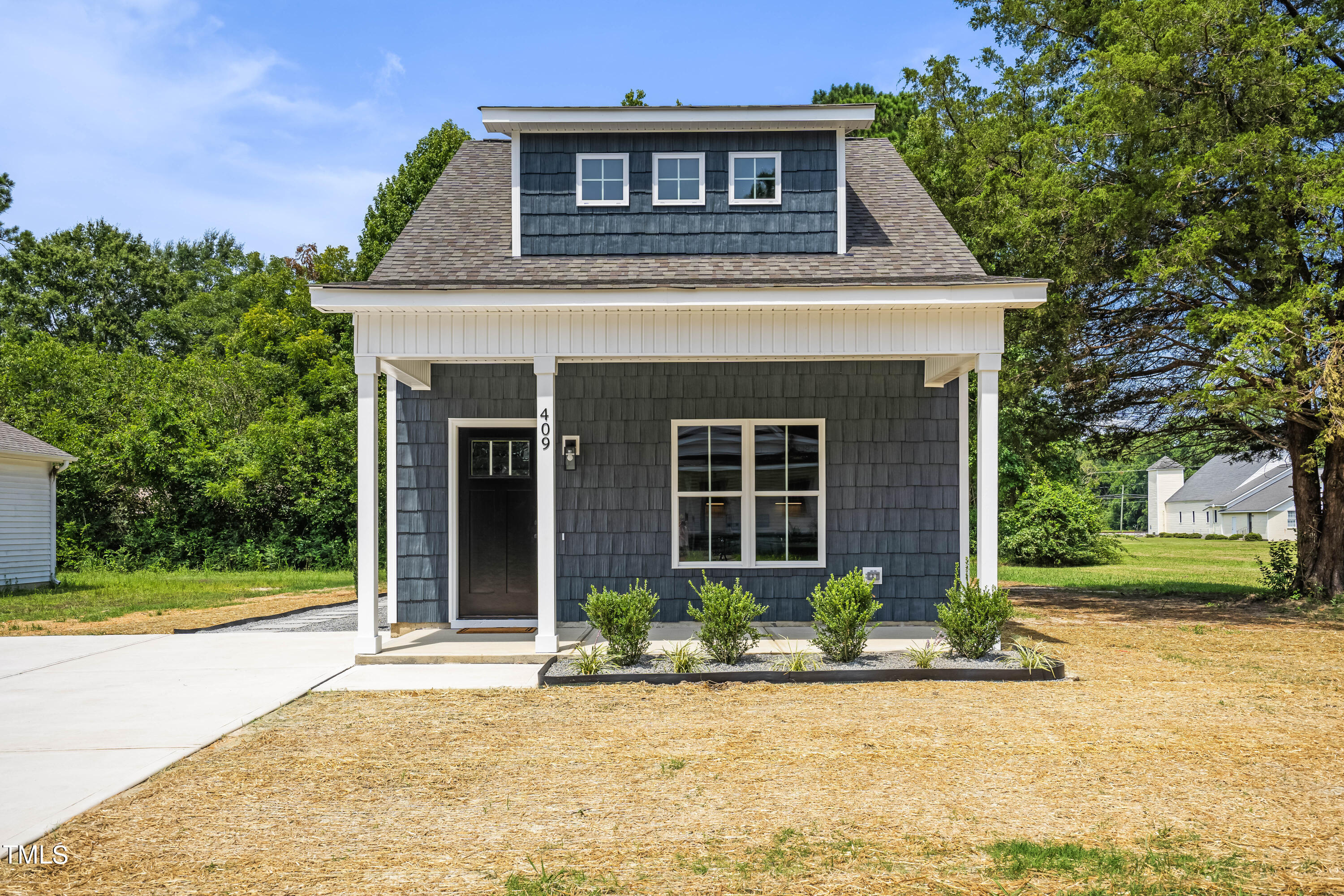 a front view of a house with garden