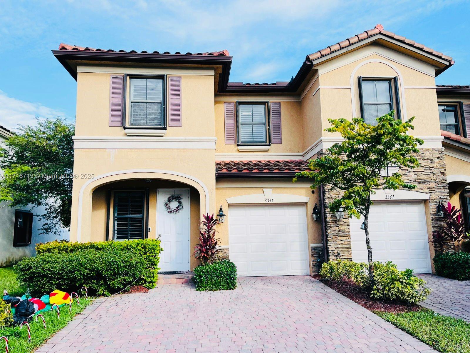 a front view of a house with garden