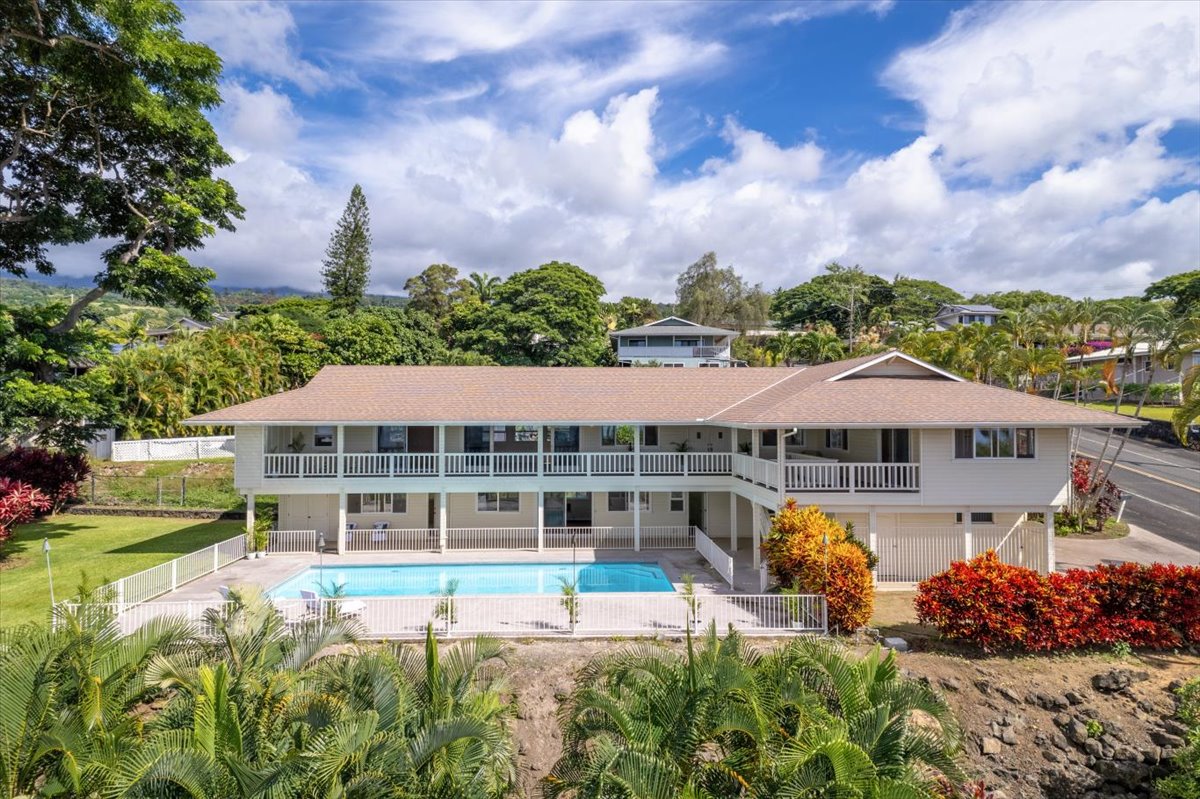 a view of a house with a garden and lake view