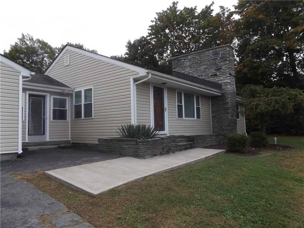 View of front of house featuring a front yard and a patio