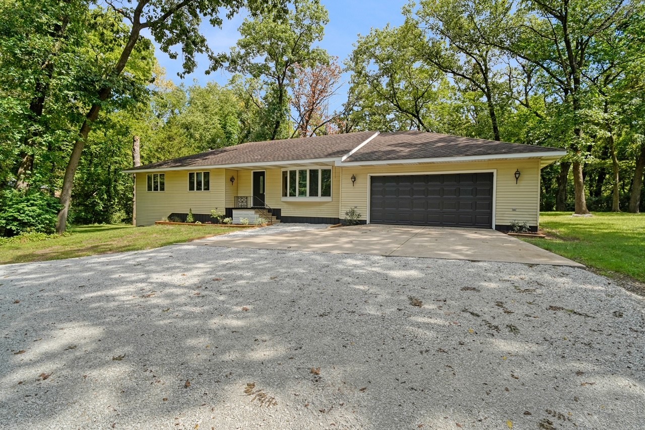 a front view of house with yard and green space